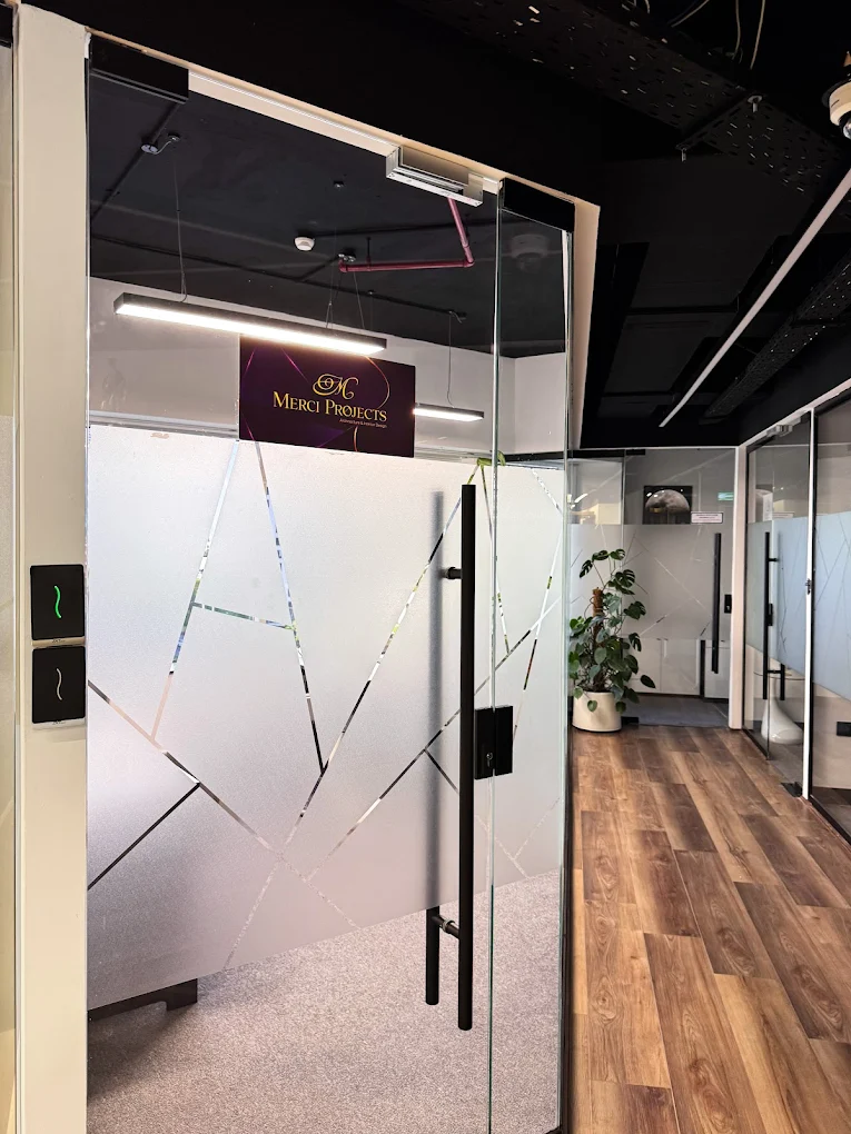 Glass entrance and corridor inside the Merci Projects Dubai studio